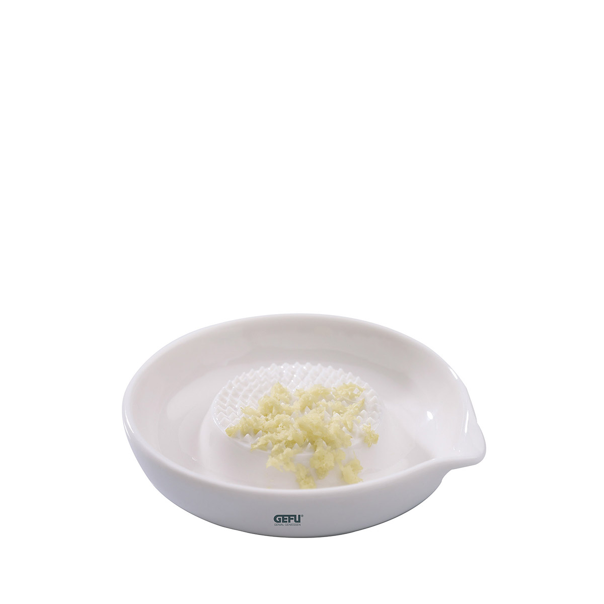 Weiße Knoblauchreibe aus Keramik mit geriebenem Knoblauch Runde weiße Keramikreibe für Knoblauch mit geriebenem Knoblauch in der Mitte