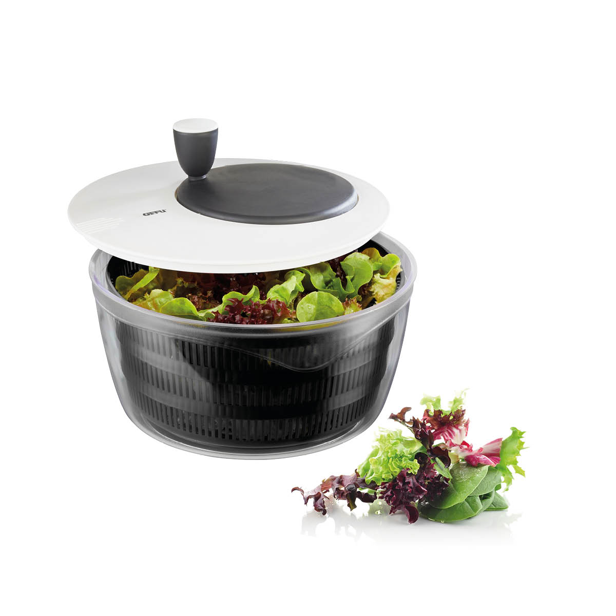Salatschleuder mit transparentem Behälter und frischem Salat Salatschleuder mit Deckel, gefüllt mit frischem Salat, daneben etwas Salatblätter
