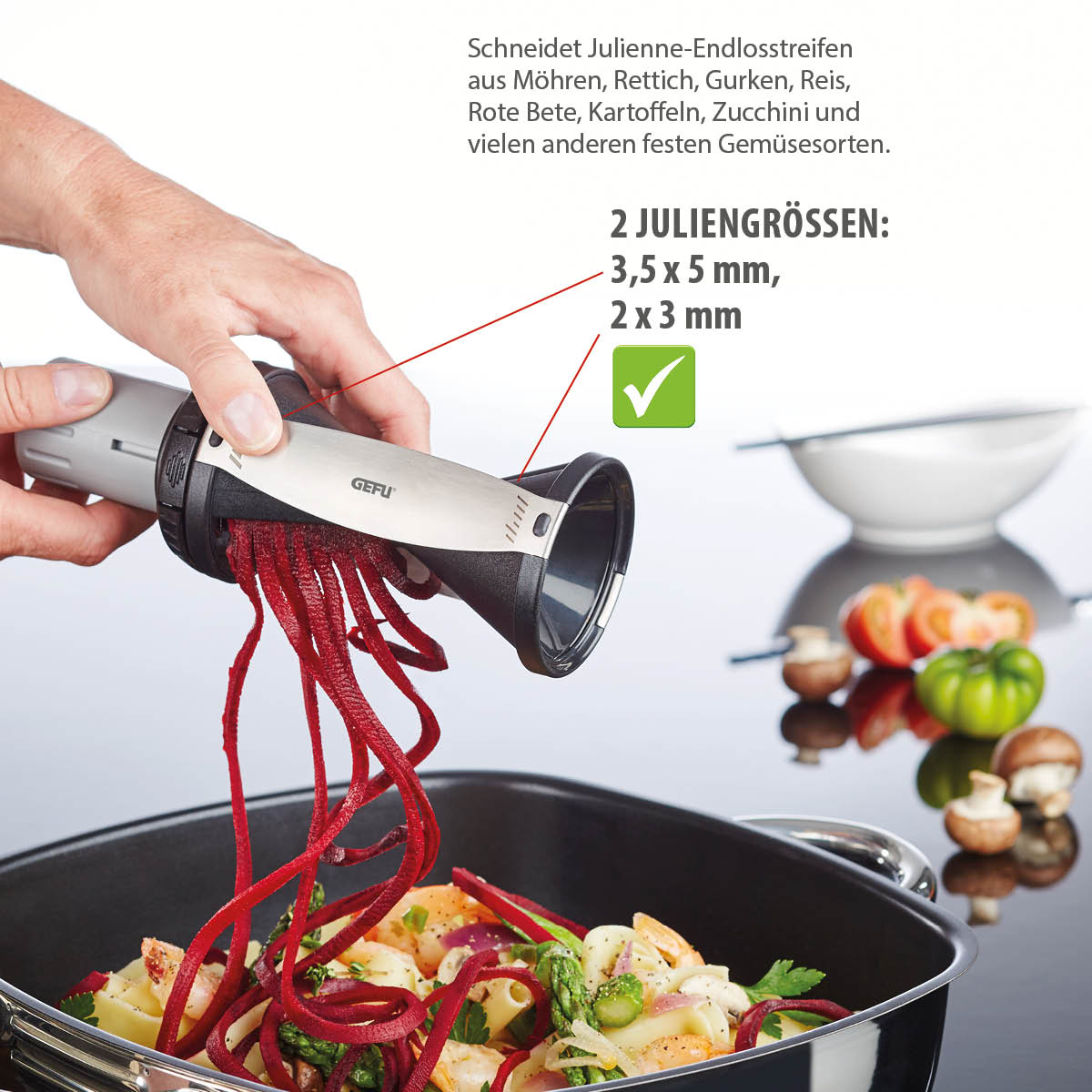 Julienneschneider für Gemüse mit zwei Schnittgrößen Hand nutzt Julienneschneider aus Metall und Kunststoff, um rote Bete in Streifen über einem Topf mit Gemüse zu schneiden.