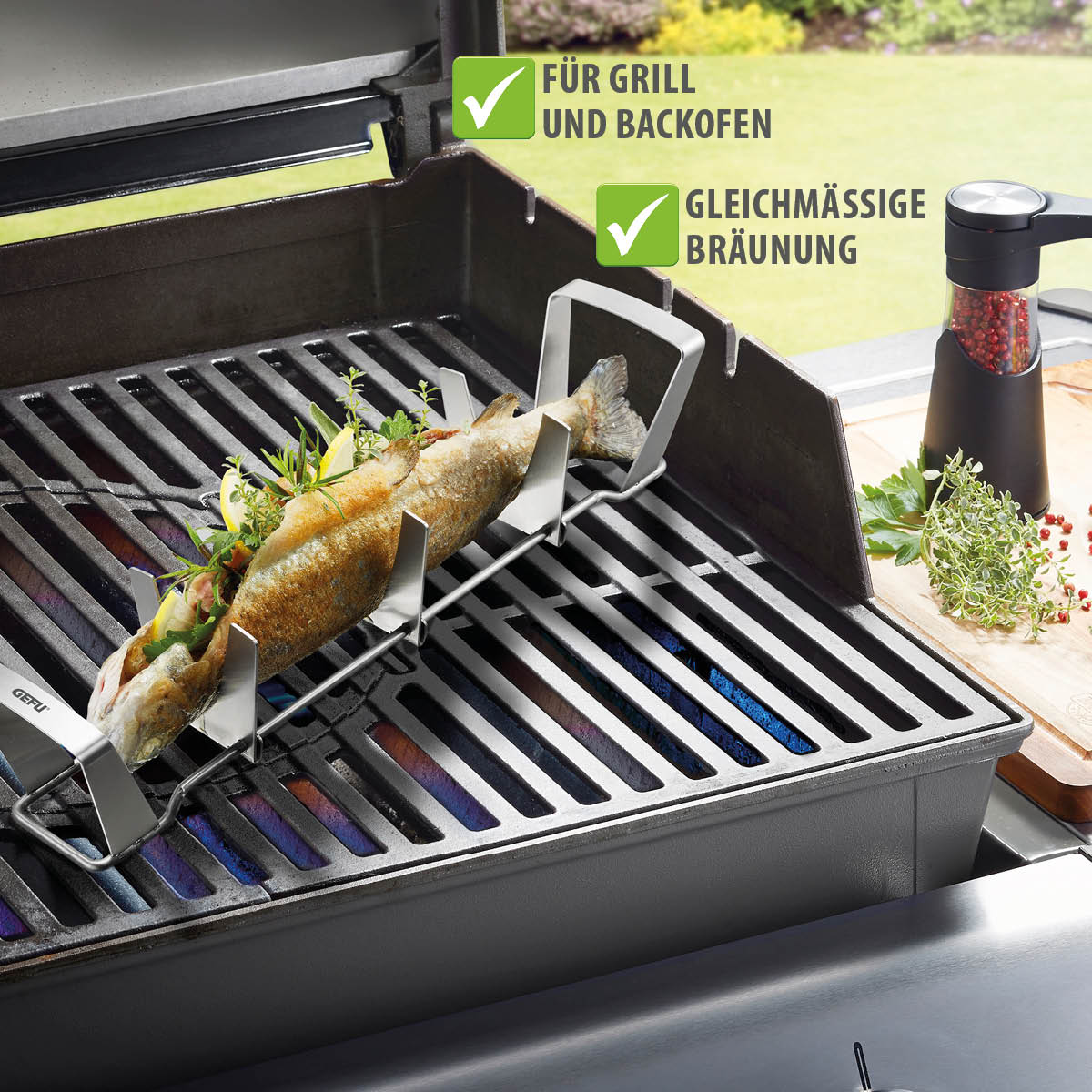 Fischhalter für gleichmäßige Bräunung auf Grill und im Backofen Fischhalter auf Grill mit Fisch, Gemüse und Kräutern, Text: Für Grill und Backofen, Gleichmäßige Bräunung