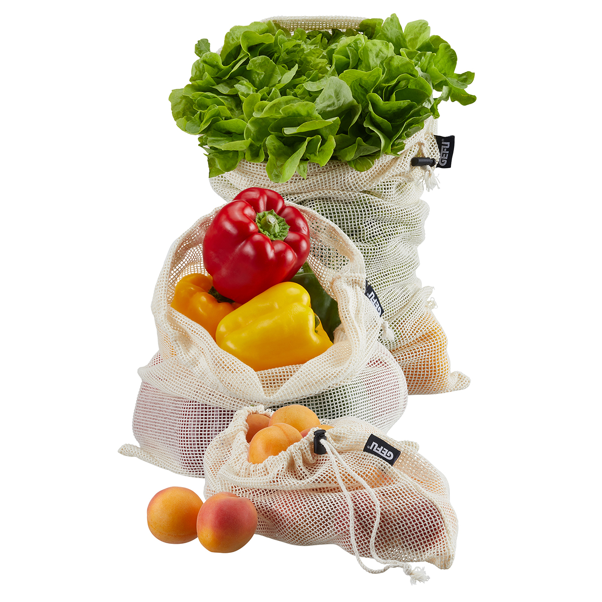 Nachhaltige Gemüse- und Obstbeutel aus Baumwolle Drei wiederverwendbare Netzbeutel gefüllt mit Salat, Paprika und Aprikosen
