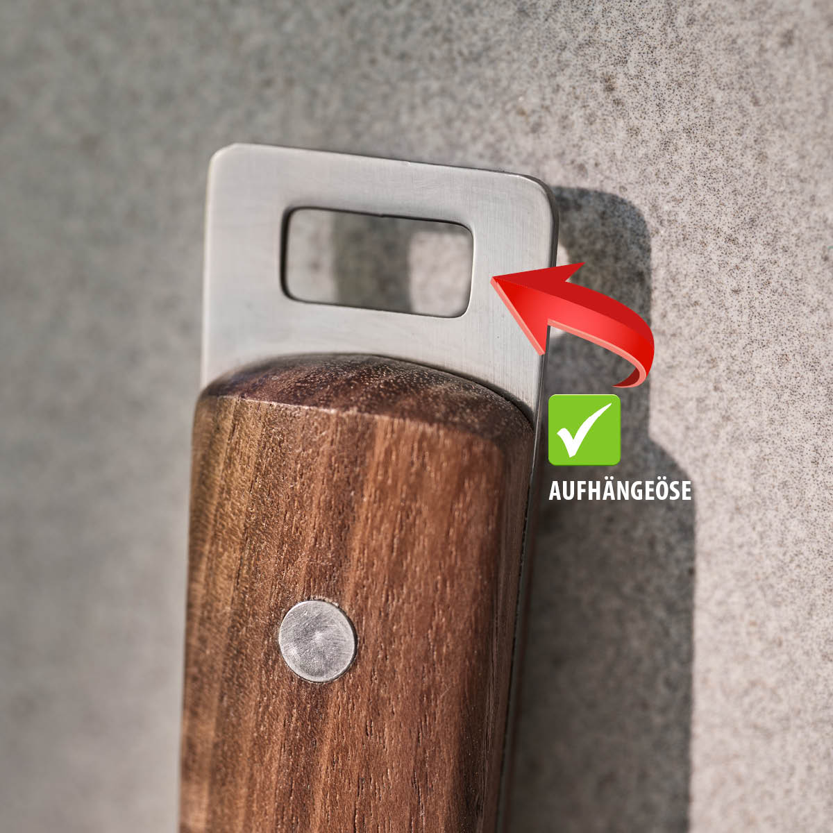 Nahaufnahme eines Küchenwerkzeugs mit Holzgriff und Aufhängeöse aus Metall
