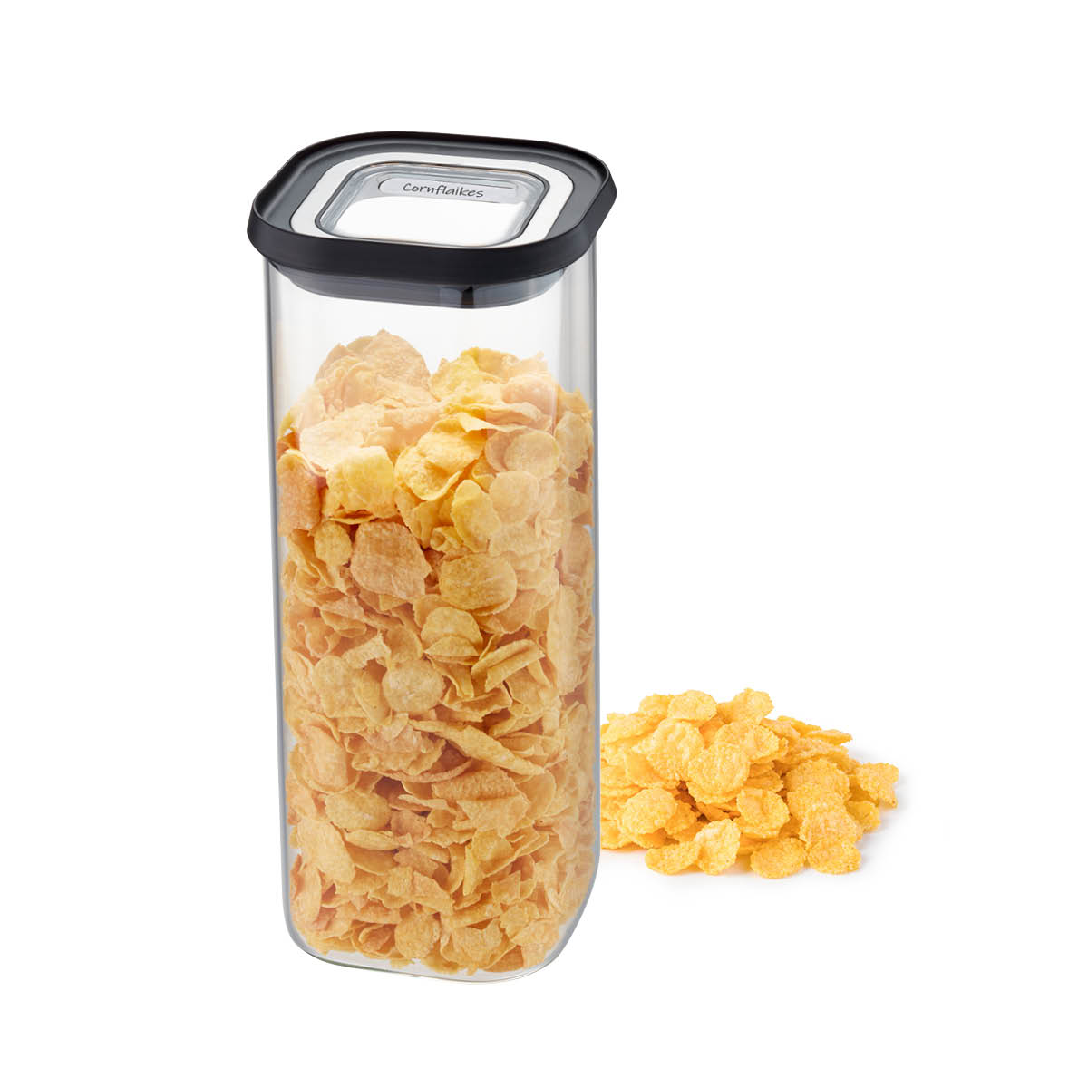 Transparenter Vorratsbehälter mit Cornflakes Transparenter Vorratsbehälter mit Cornflakes gefüllt, daneben ein kleiner Haufen Cornflakes