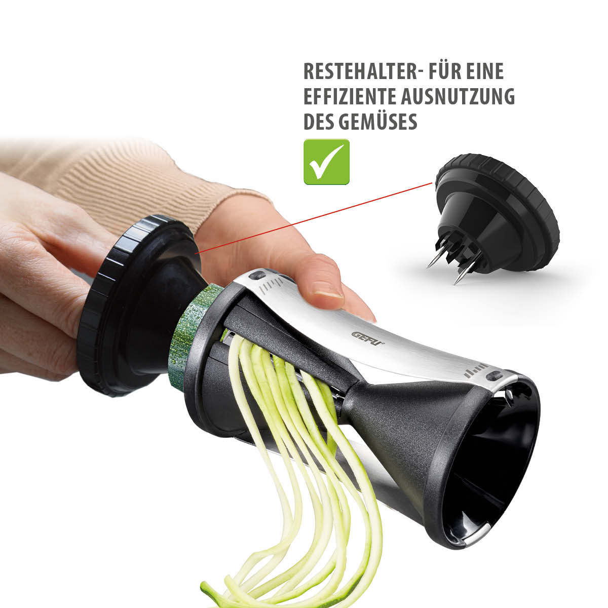 Spiralschneider mit Restehalter für effiziente Gemüsenutzung Hand hält Spiralschneider mit Zucchini und Restehalter für optimale Gemüsenutzung